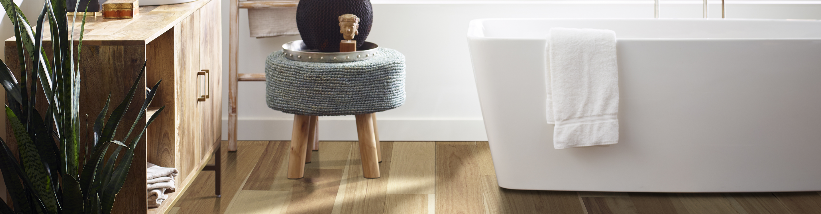 waterproof wood flooring in bathroom with white soaker tub